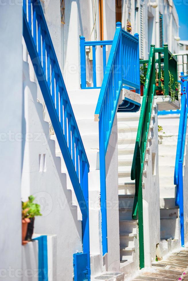 Empty narrow streets of greek island with trees. Beautiful architecture building exterior with cycladic style. photo