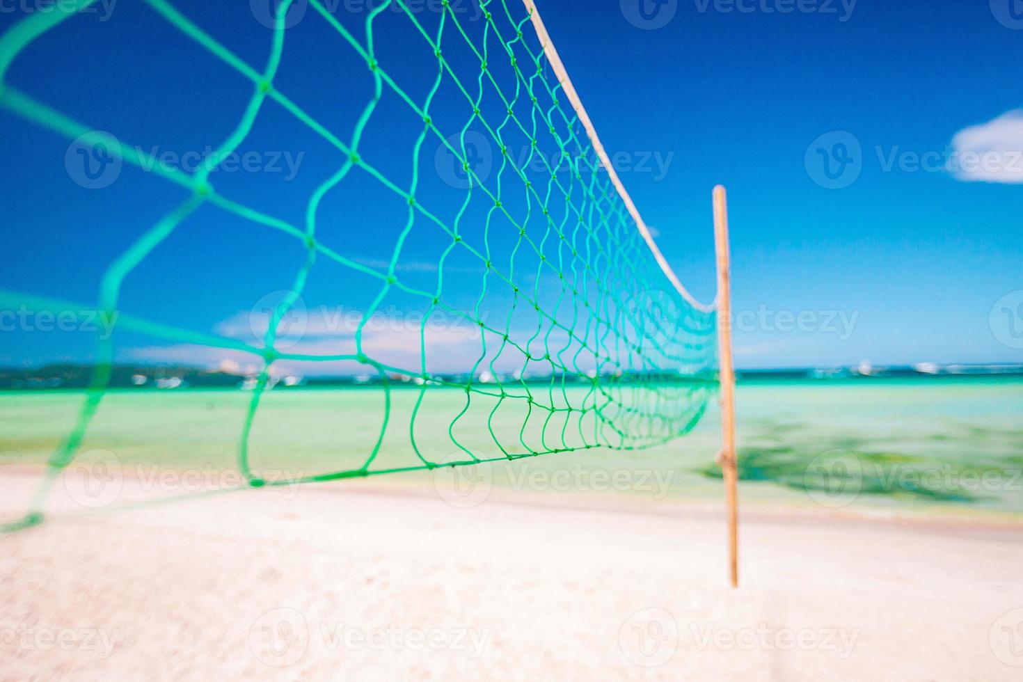 Closeup volleyball net at the empty tropical exotic beach photo