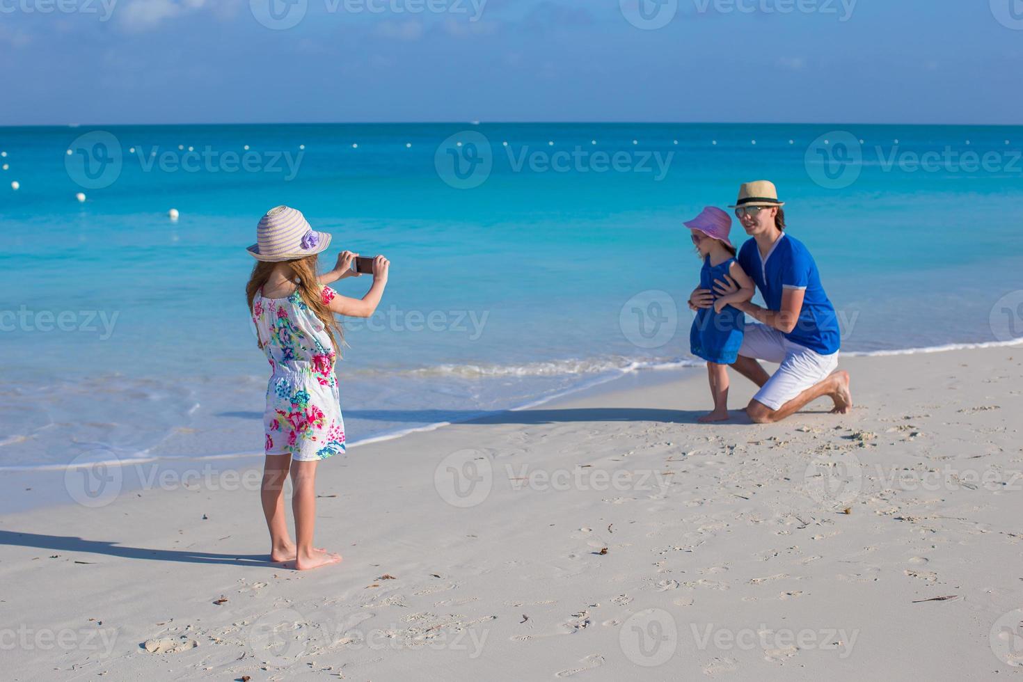 Happy family enjoying beach vacation photo