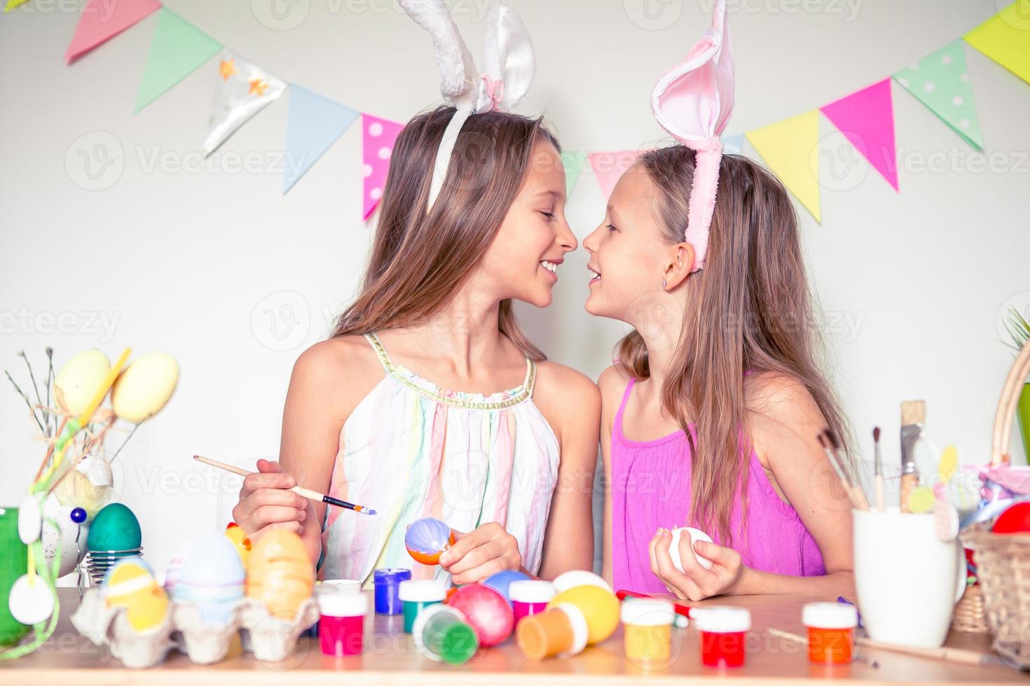 Happy easter. Beautiful little kids wearing bunny ears on Easter day. photo