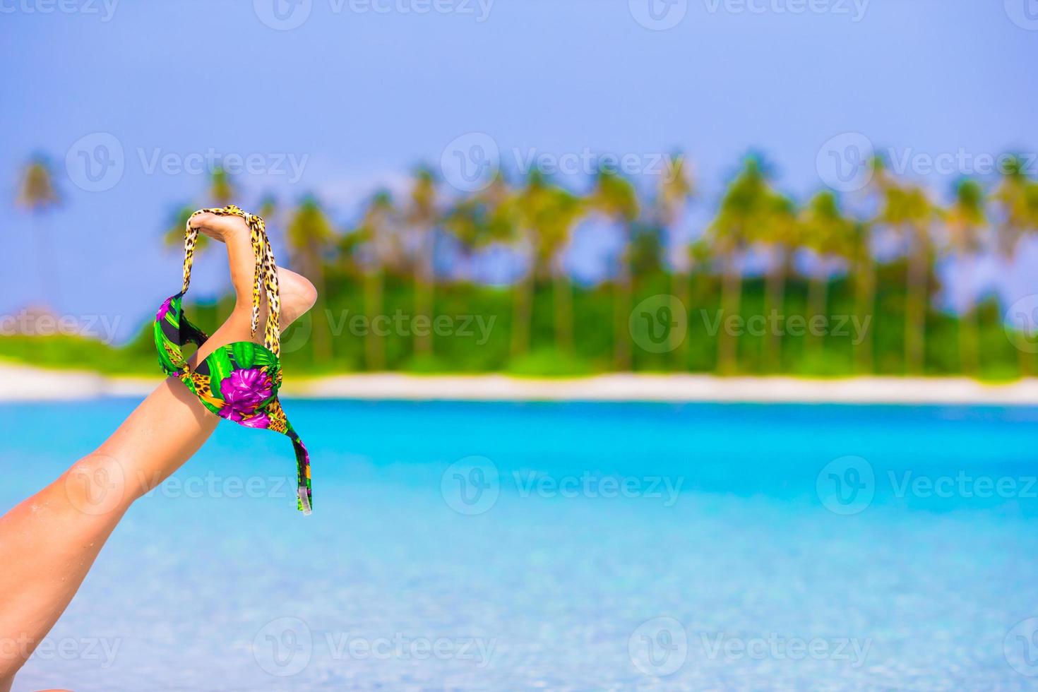 Closeup swimsuit on background of turquoise water and palmtrees photo