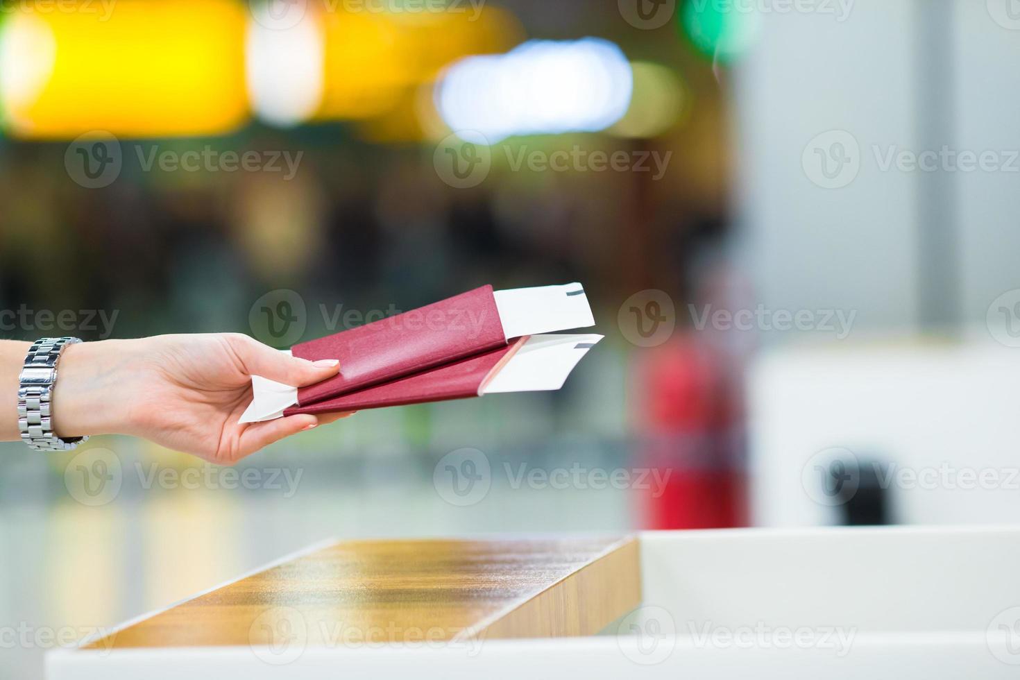 Closeup passports and boarding pass at the reception area in airport inside photo