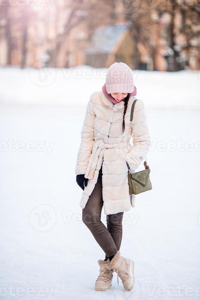 Happy young woman on ice rink outdoors photo