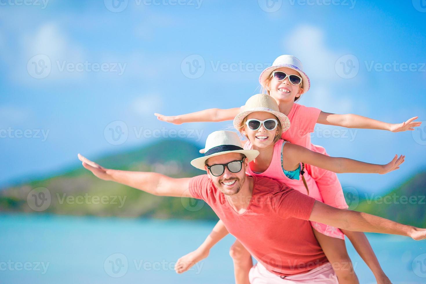 Father and kids enjoying beach summer tropical vacation photo