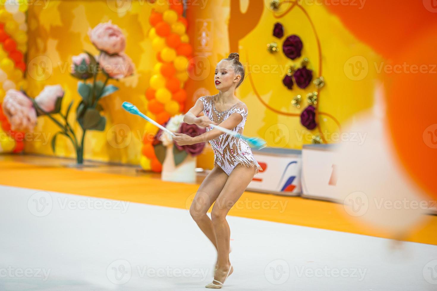 hermosa niña gimnasta activa con su actuación en la alfombra foto