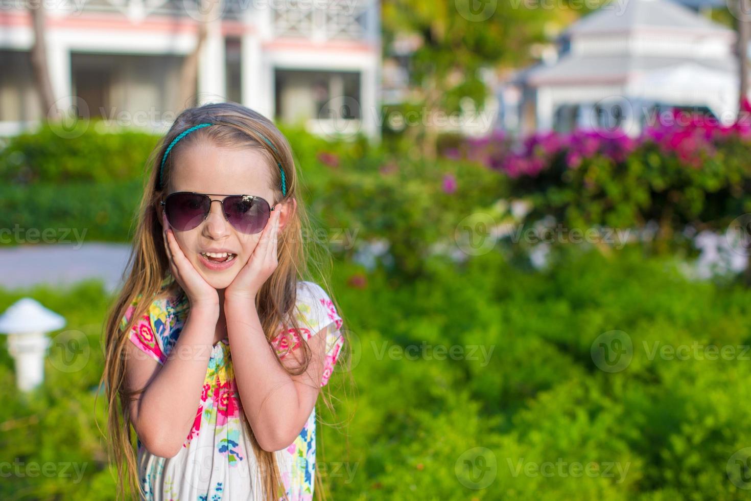 Surprised little girl on summer vacation photo