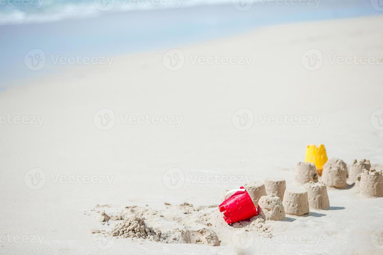 Bright kid toys on tropical sand beach photo