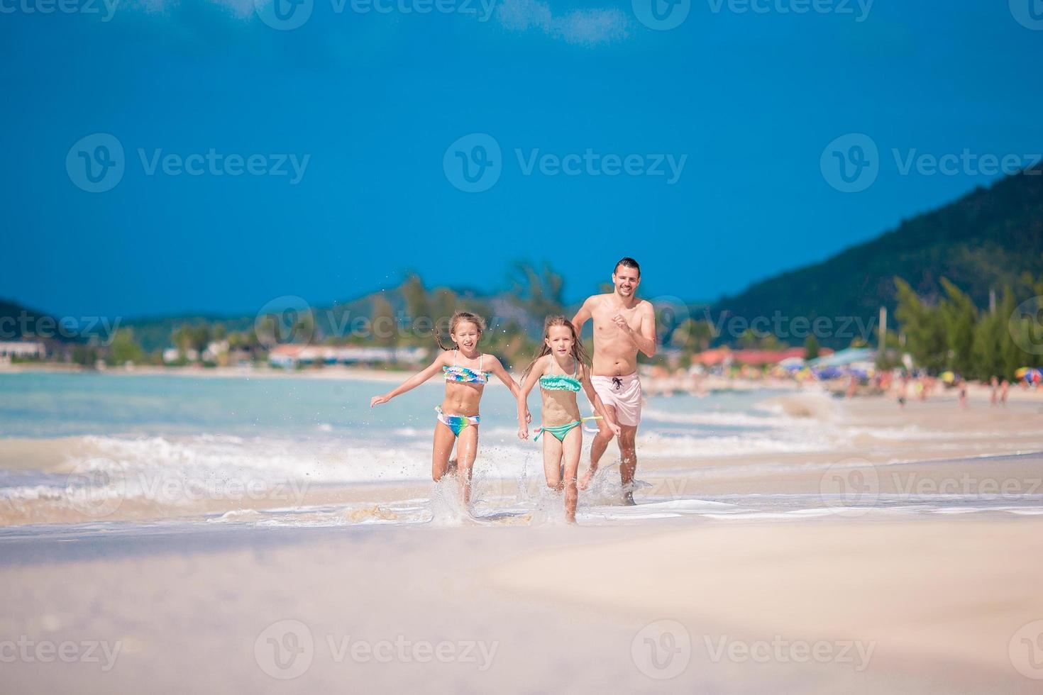Father and kids enjoying beach summer vacation photo