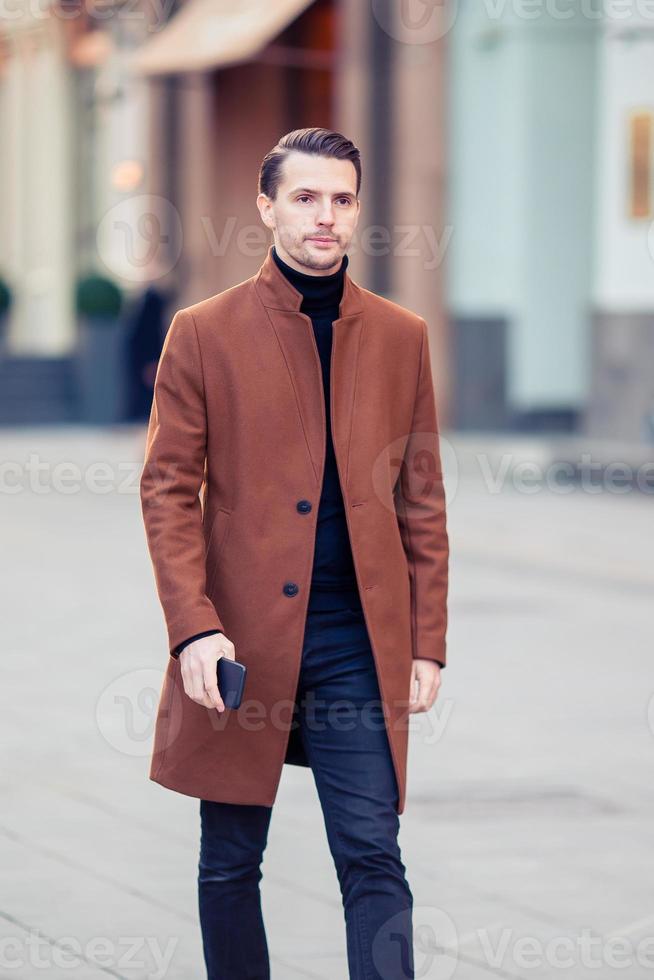 Happy young man walking at autumn day photo