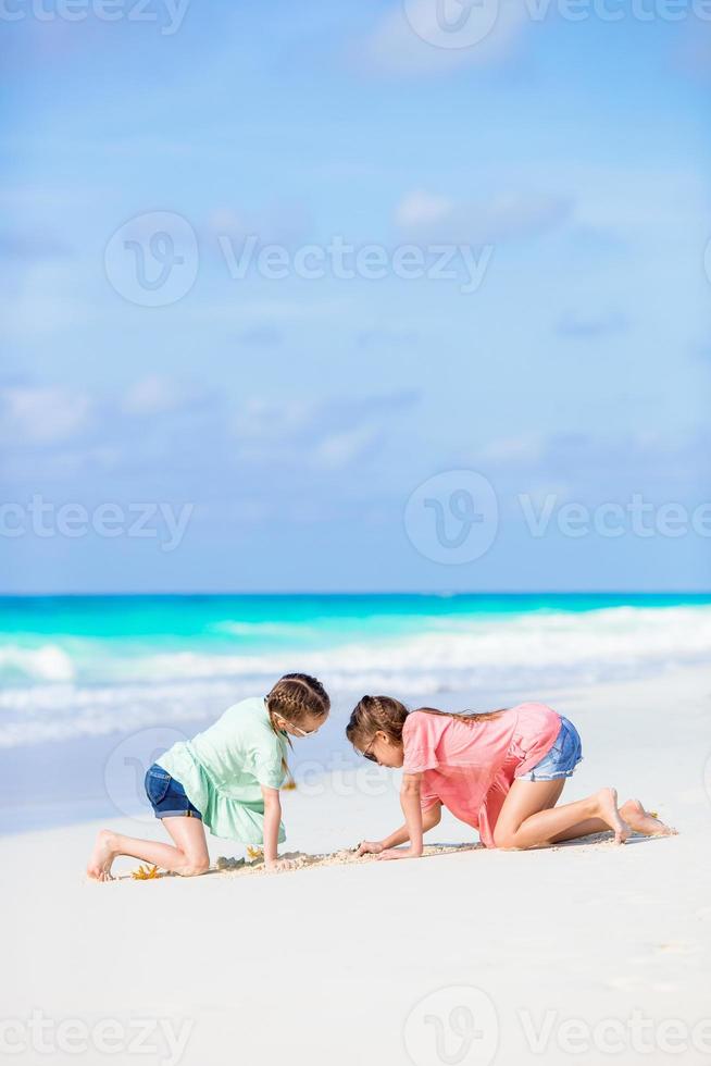 Adorable little girls during summer tropical vacation photo