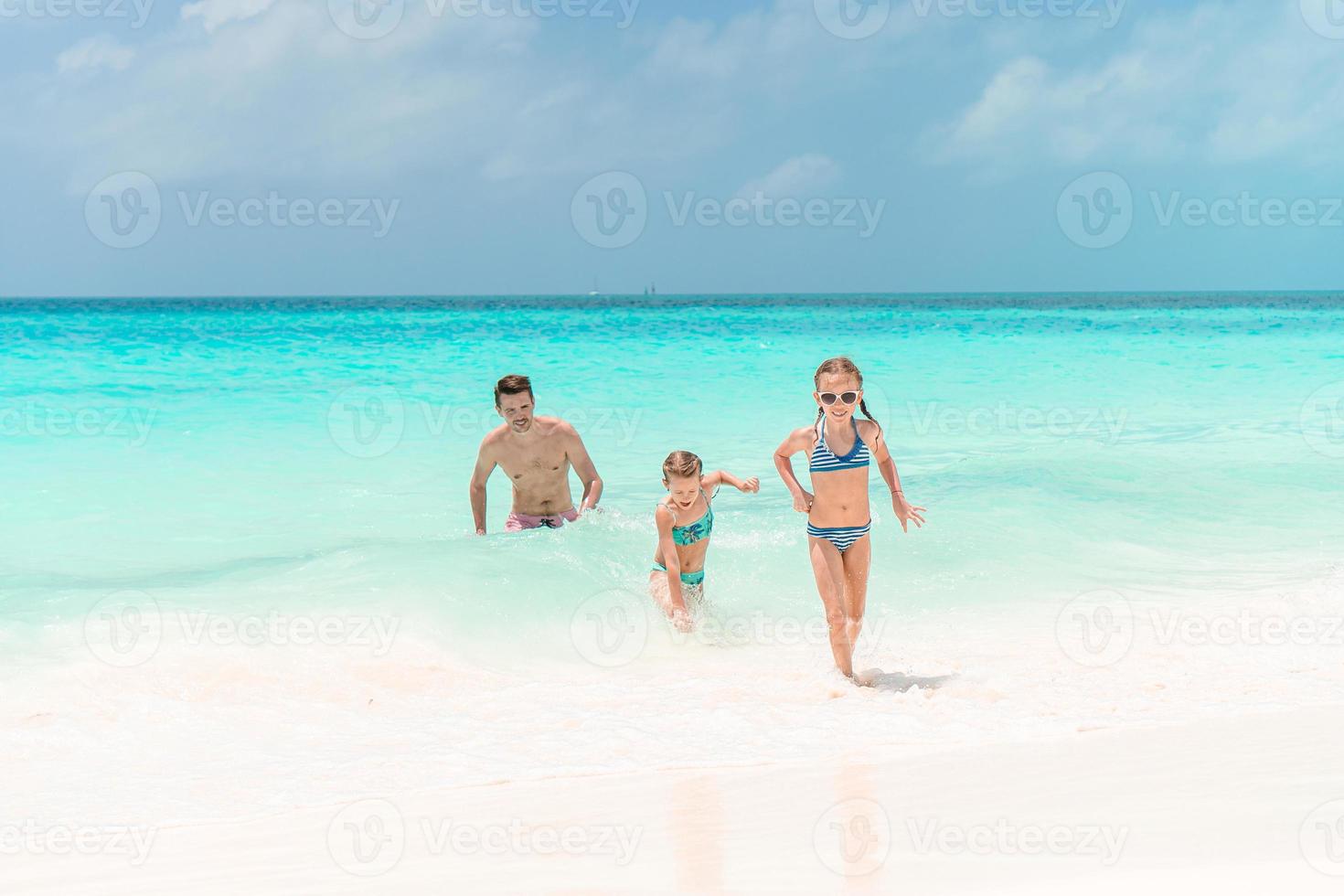 Father and kids enjoying beach summer vacation photo