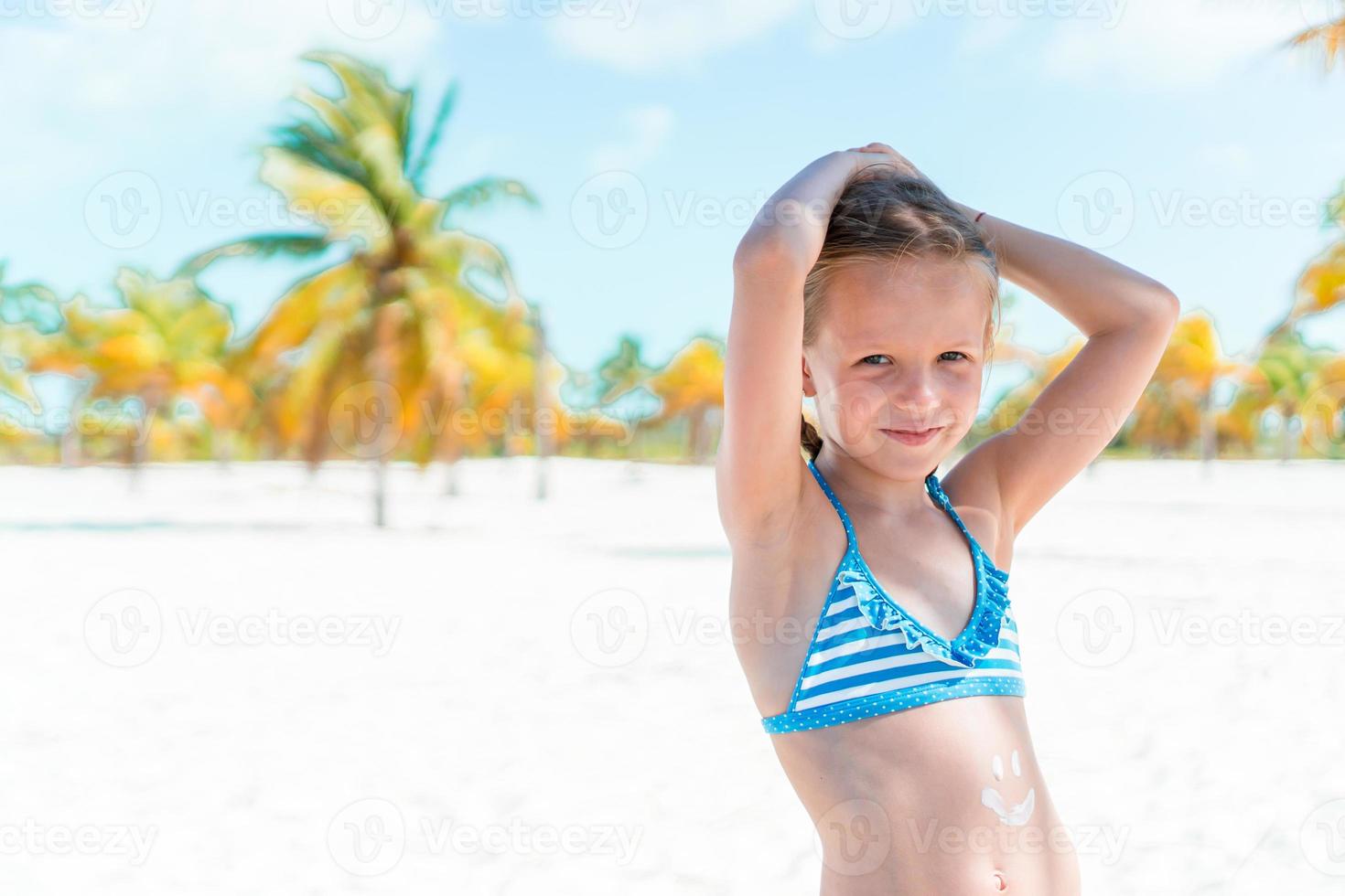 Cute little girl at beach during caribbean vacation photo