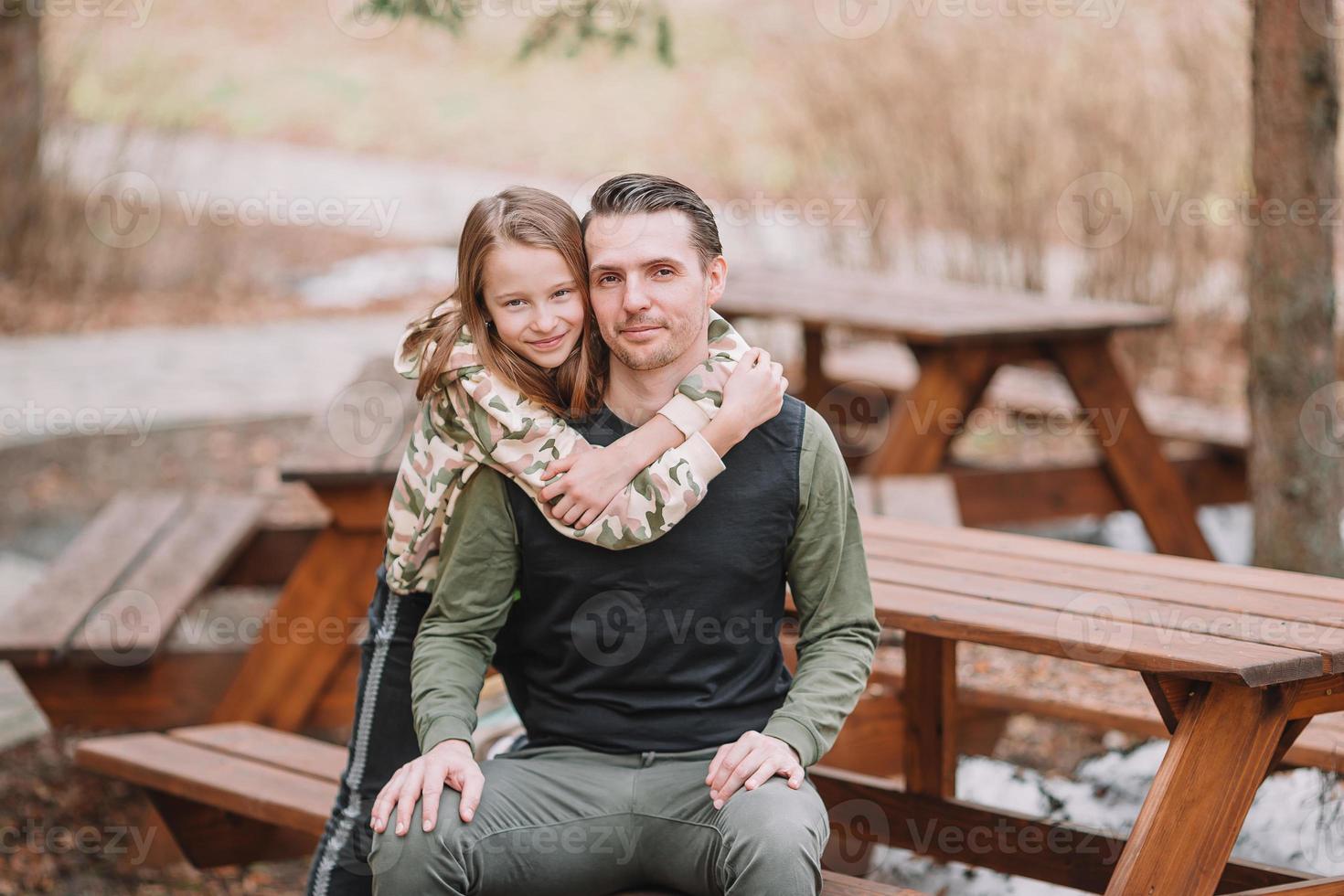 Father and cute daughters with dog outdoors photo