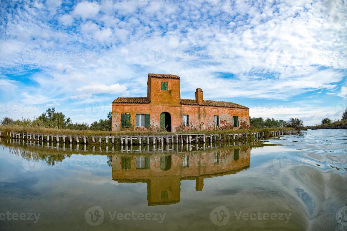 comacchio valley fisherman house on cloudy sky background photo