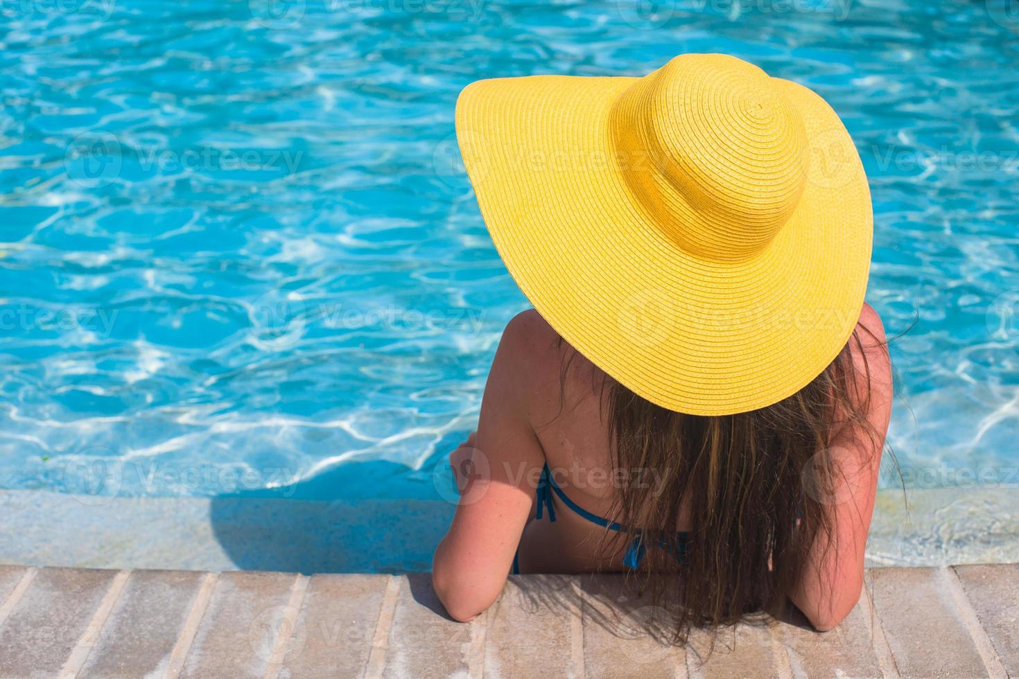 Woman in yellow hat relaxing at swimming pool 17703543 Stock Photo at  Vecteezy