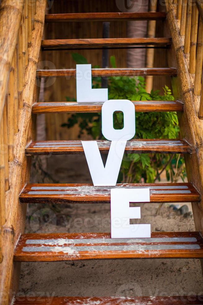 Word love on sandy beach at beautiful resort photo