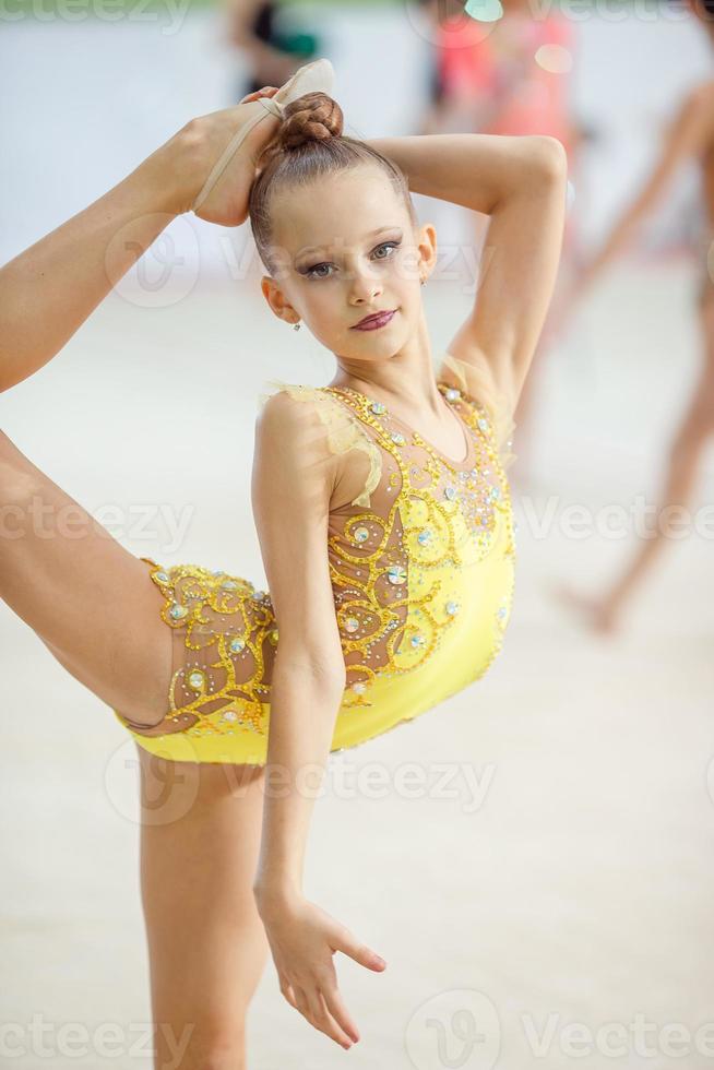 Little gymnast training on the carpet and ready for competitions photo