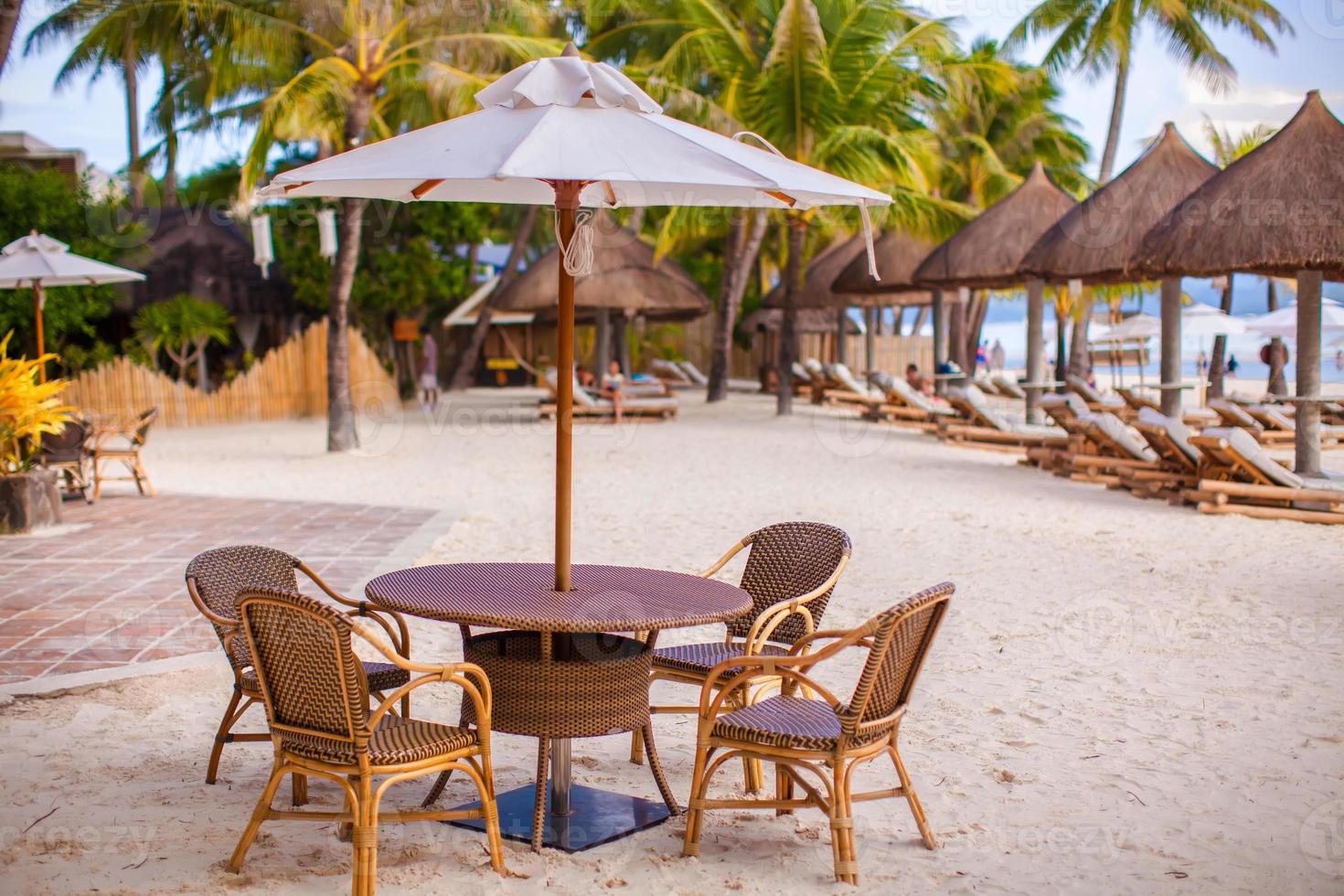 Outdoor cafe on tropical beach photo