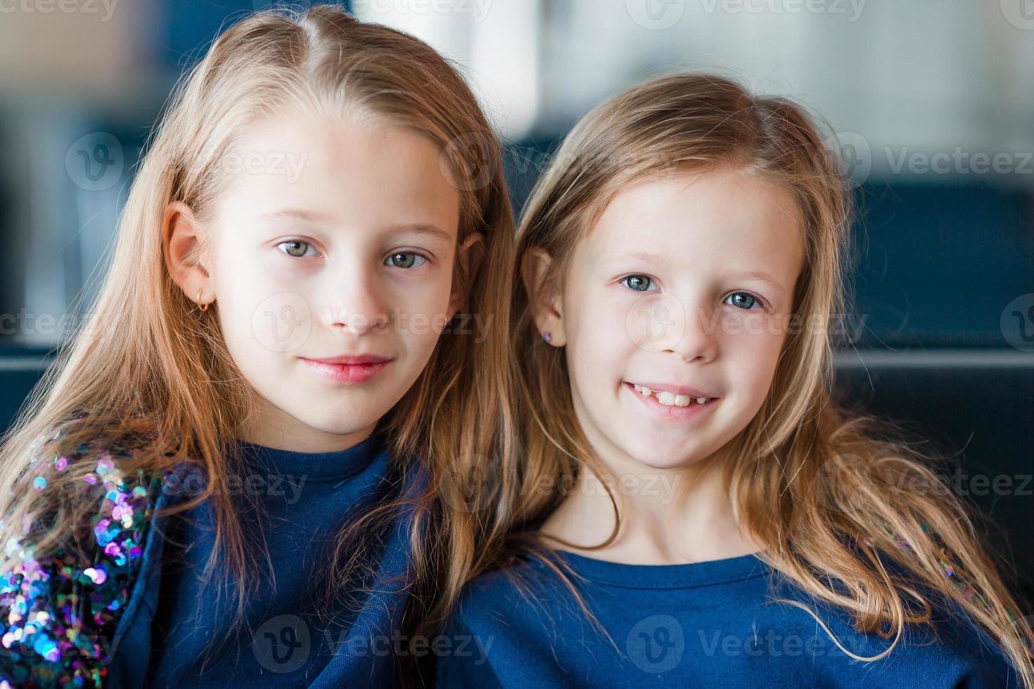 Little girls in airport while wait for boarding photo