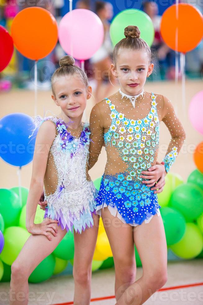 Little gymnast training on the carpet and ready for competitions photo