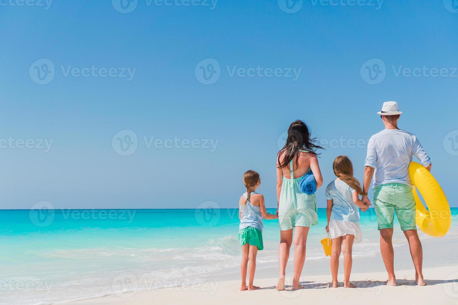 Happy beautiful family on white beach having fun photo