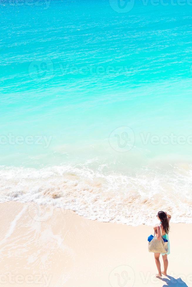 Happy girl at beach having a lot of fun in shallow water photo