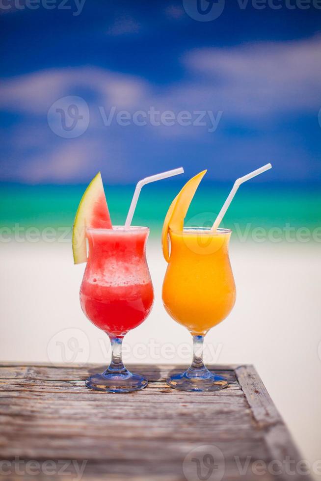 Two cocktails fresh watermelon and mango on background of stunning turquoise sea photo