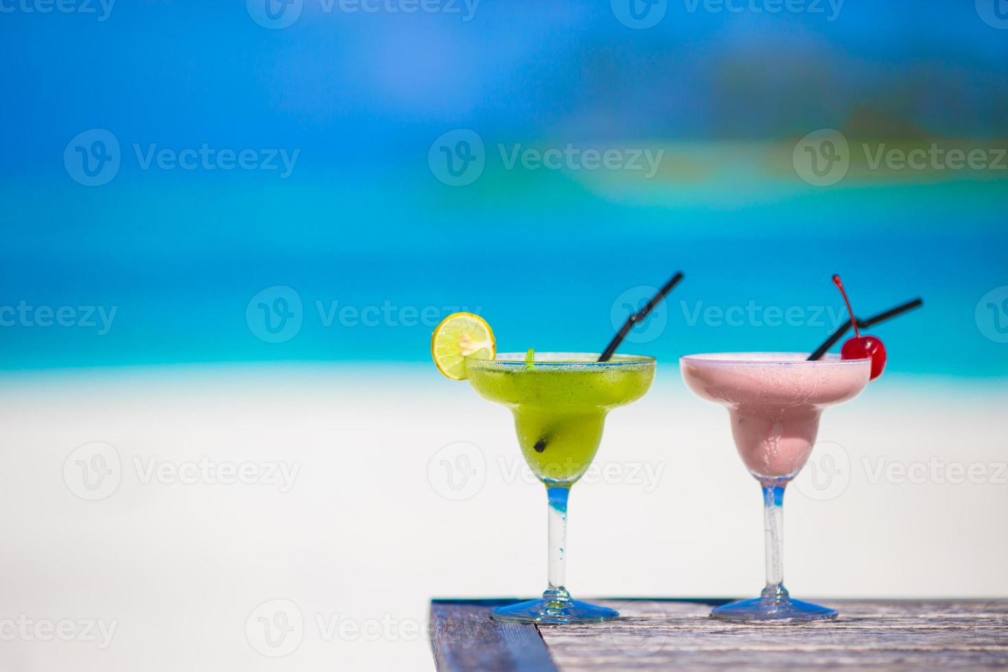 Two tasty cocktails on tropical white beach photo