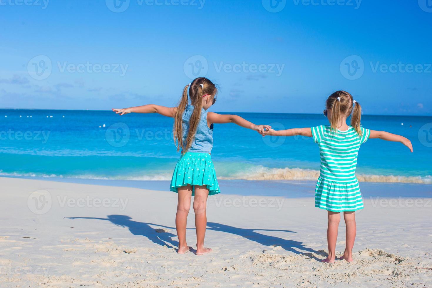 Little adorable girls enjoy summer beach vacation photo