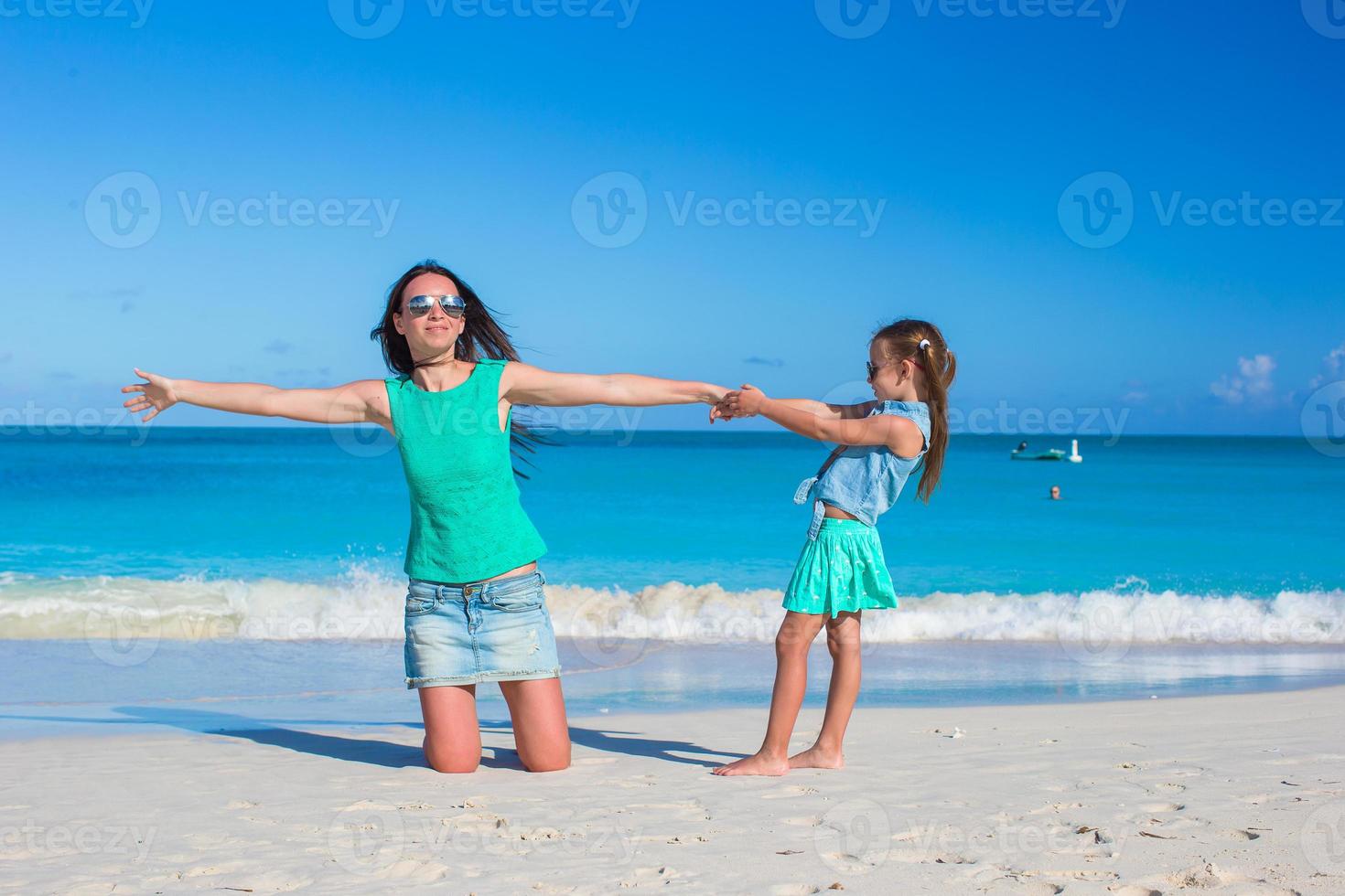 Young mother and adorable little daughter enjoy summer vacation photo