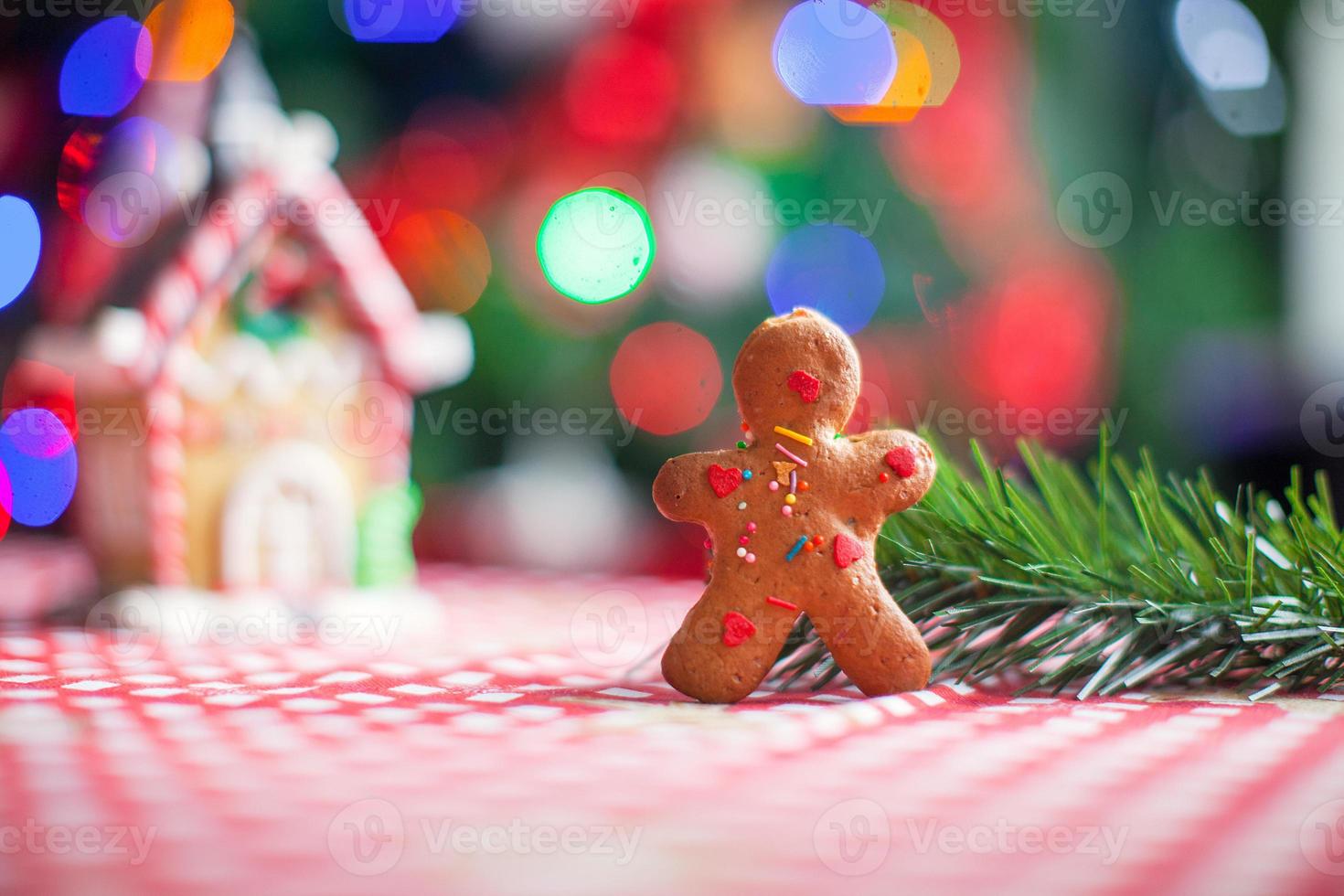 Gingerbread man background candy ginger house and Christmas tree lights photo