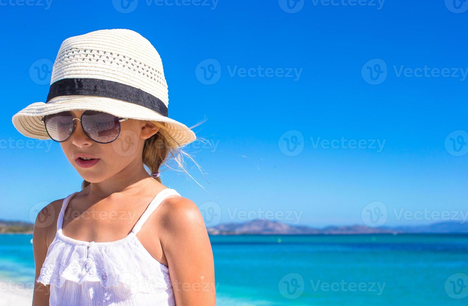 Portrait of Little happy girl enjoying beach vacation photo