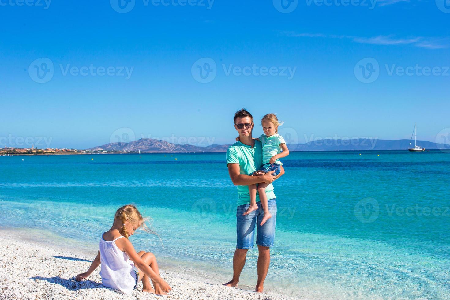 Family of three having fun during their tropical vacation photo