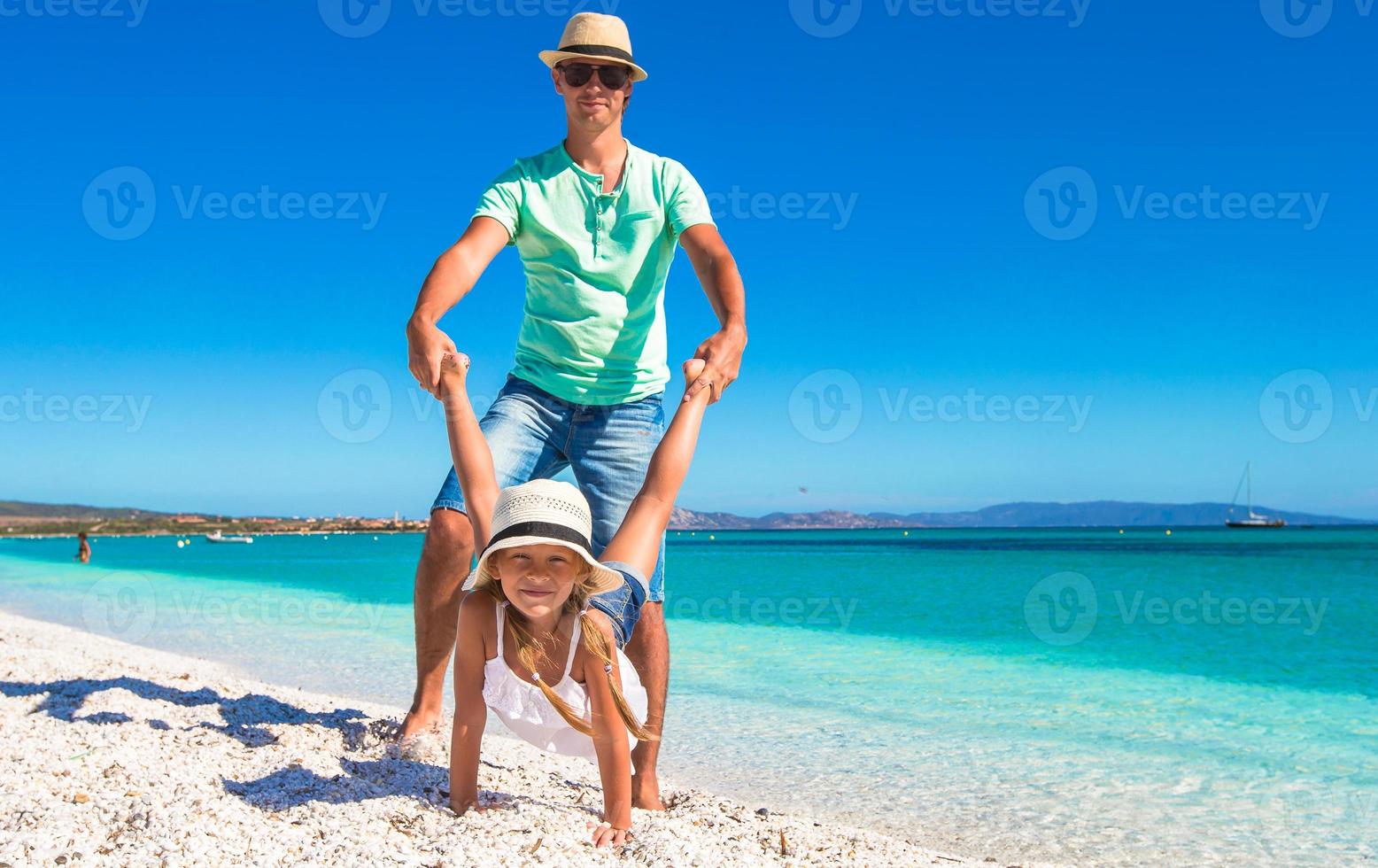 Happy dad and little girl have fun on tropical vacation photo