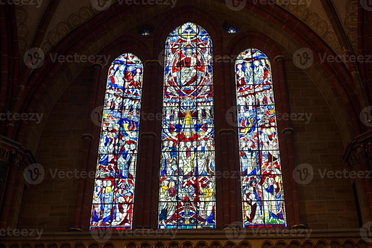 Stained glass church window in reddish tone photo