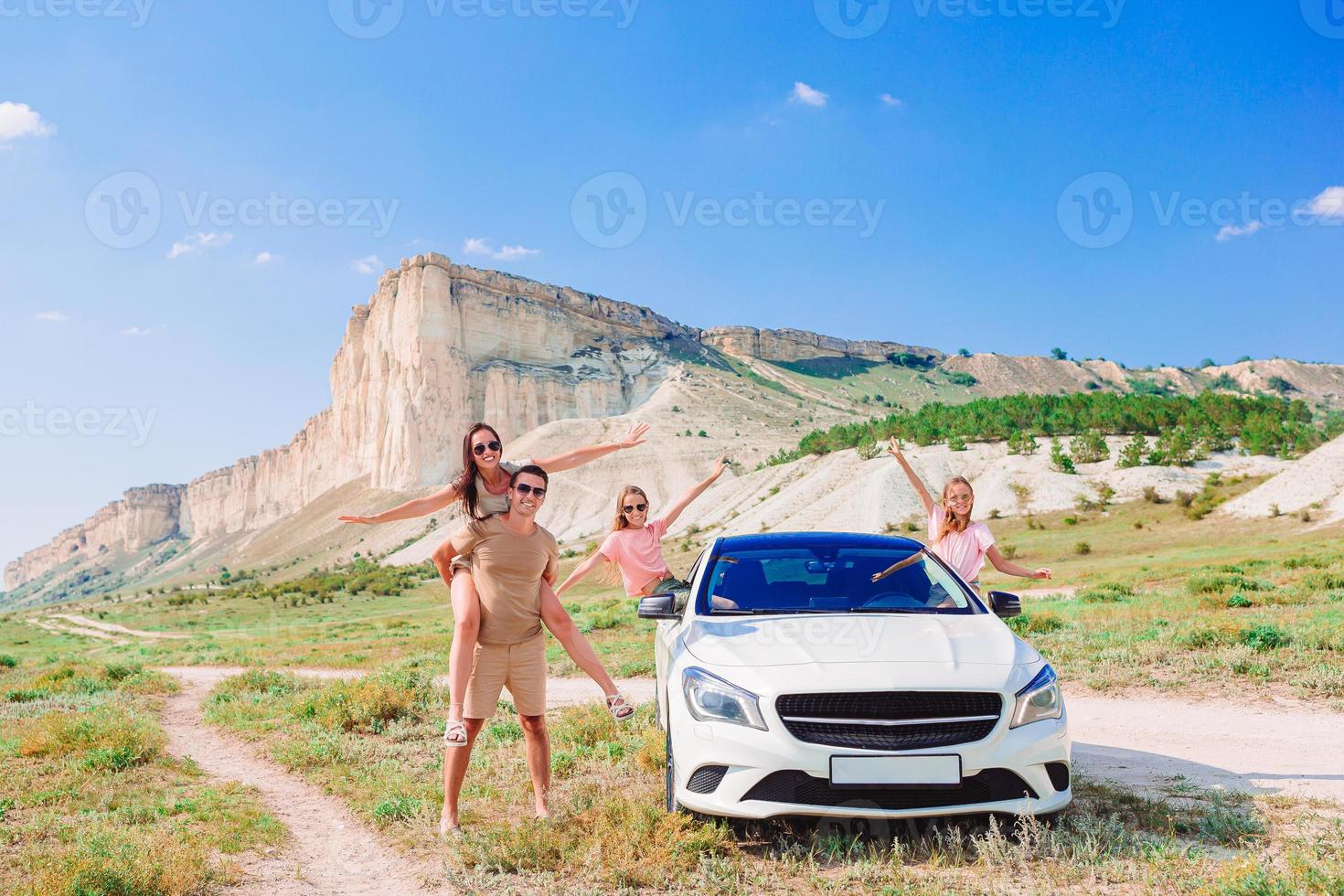 Parents and two little kids on summer car vacation photo