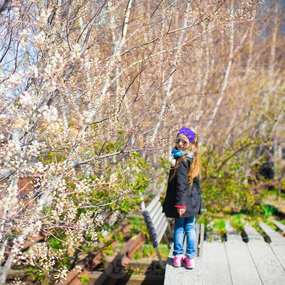 Adorable little girl enjoy sunny day on New York's High Line photo