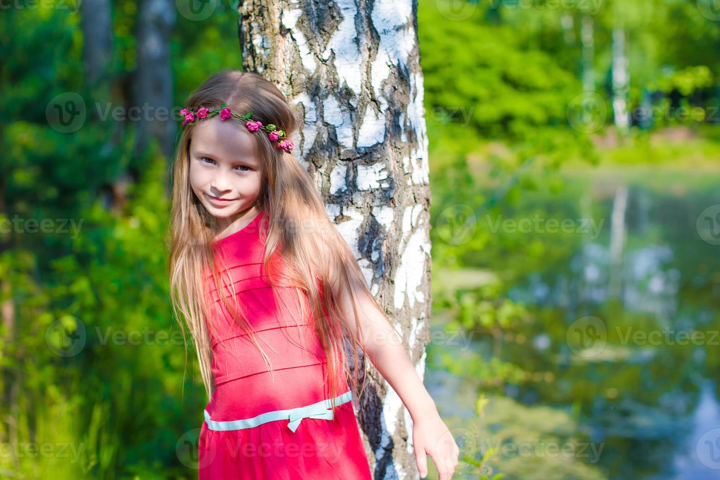 Little adorable girl during summer vacation photo