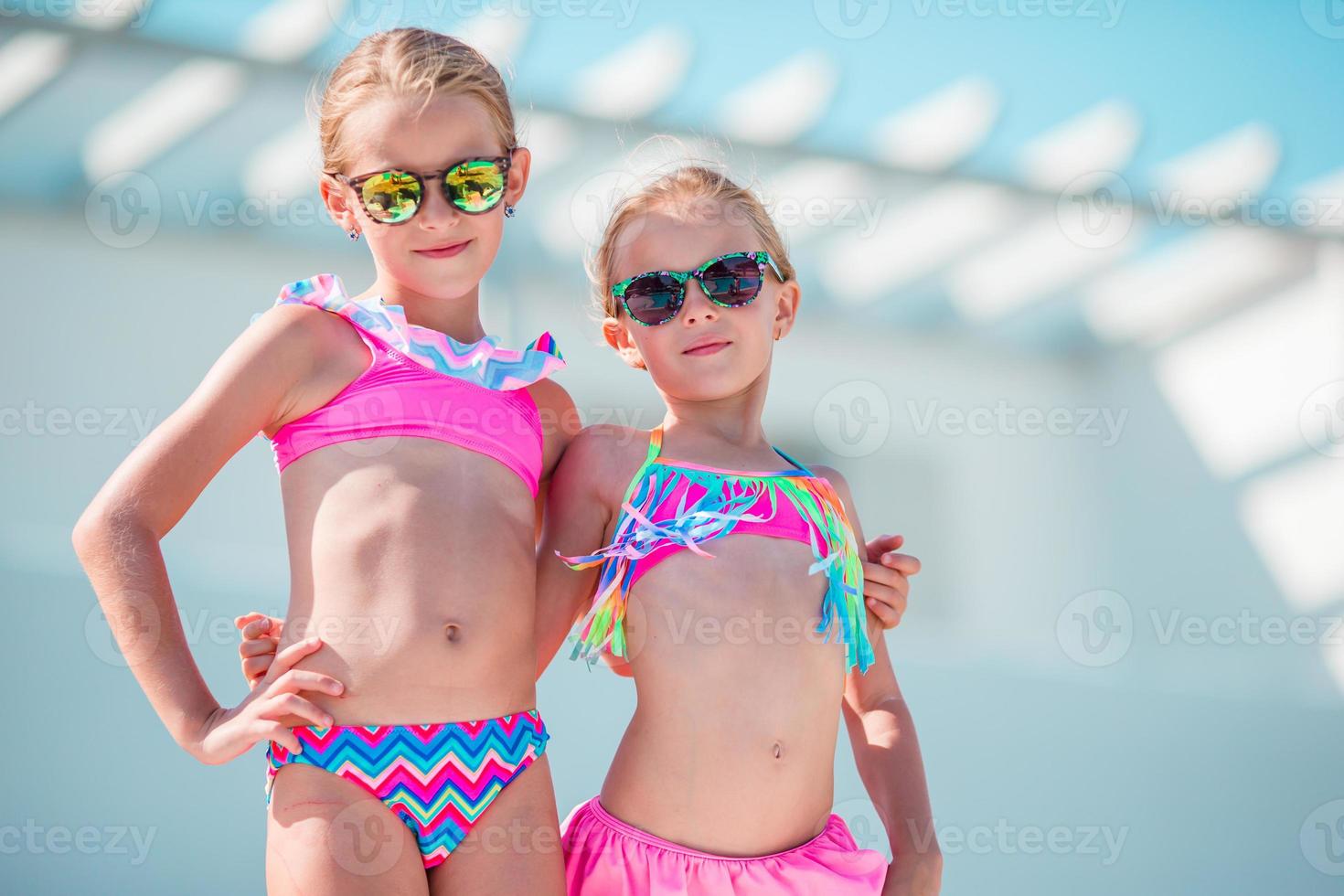 Portrait of adorable little girls having fun on summer vacation photo