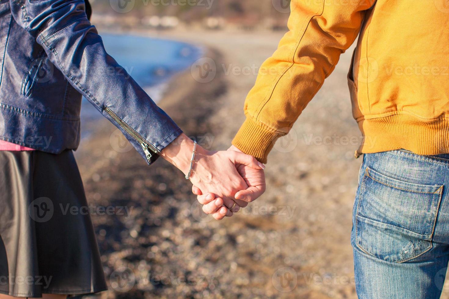 Female and male hand on a background of winter sea photo