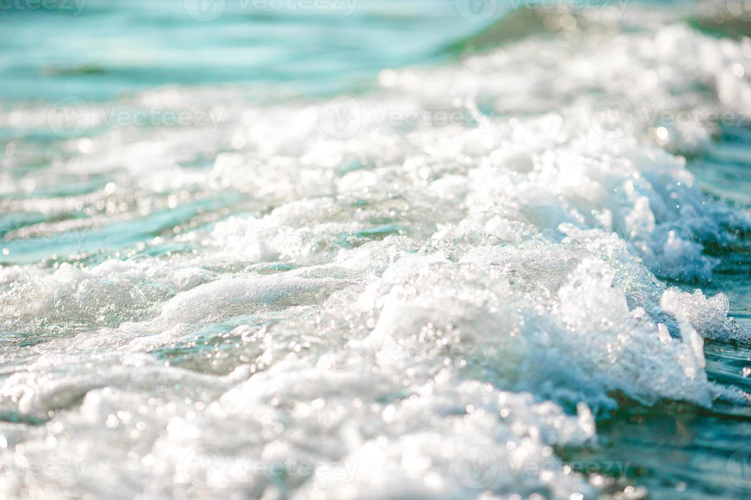 The shimmering sun shines on the sea floor. Wild wave on the sea photo