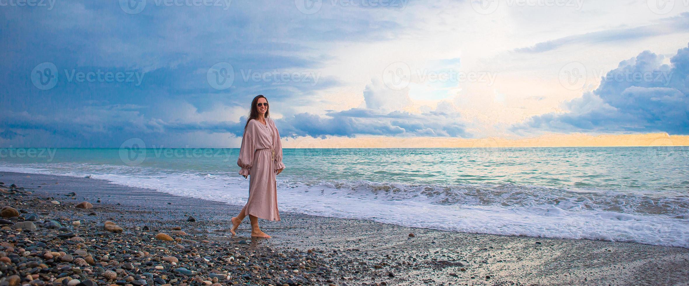 Woman on the beach enjoying summer holidays photo