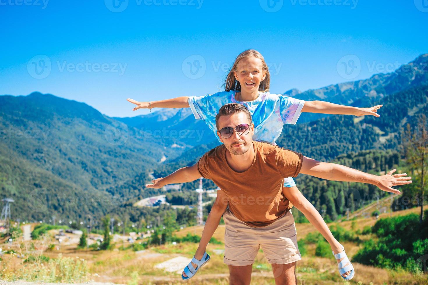 Beautiful happy family in mountains in the background photo