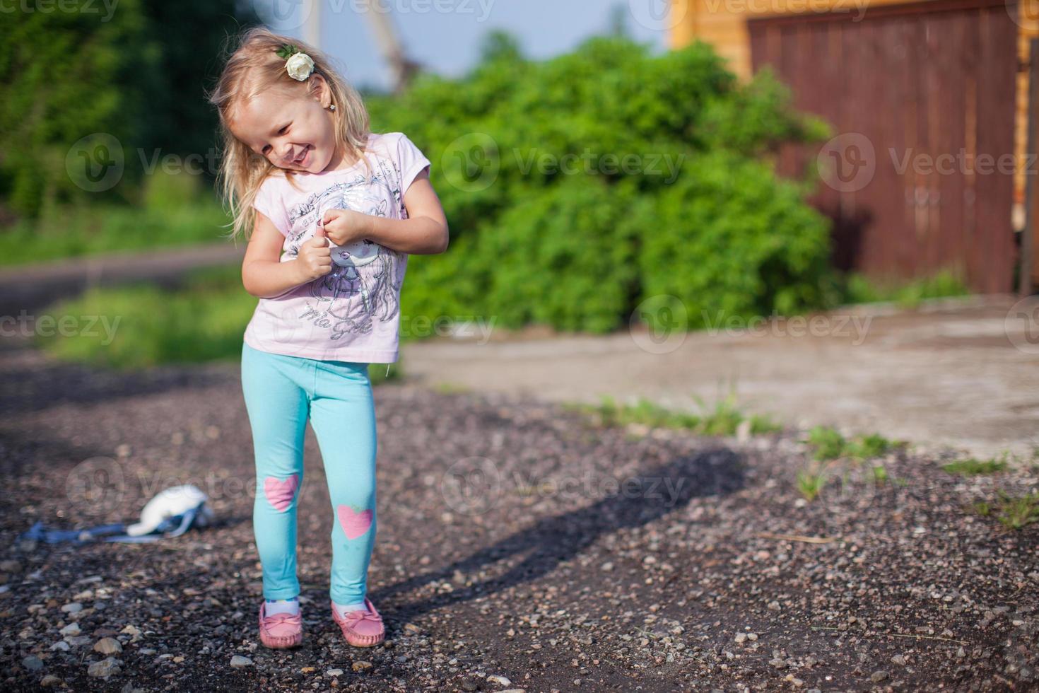 Little girl walking outdoor, having fun and laughting photo