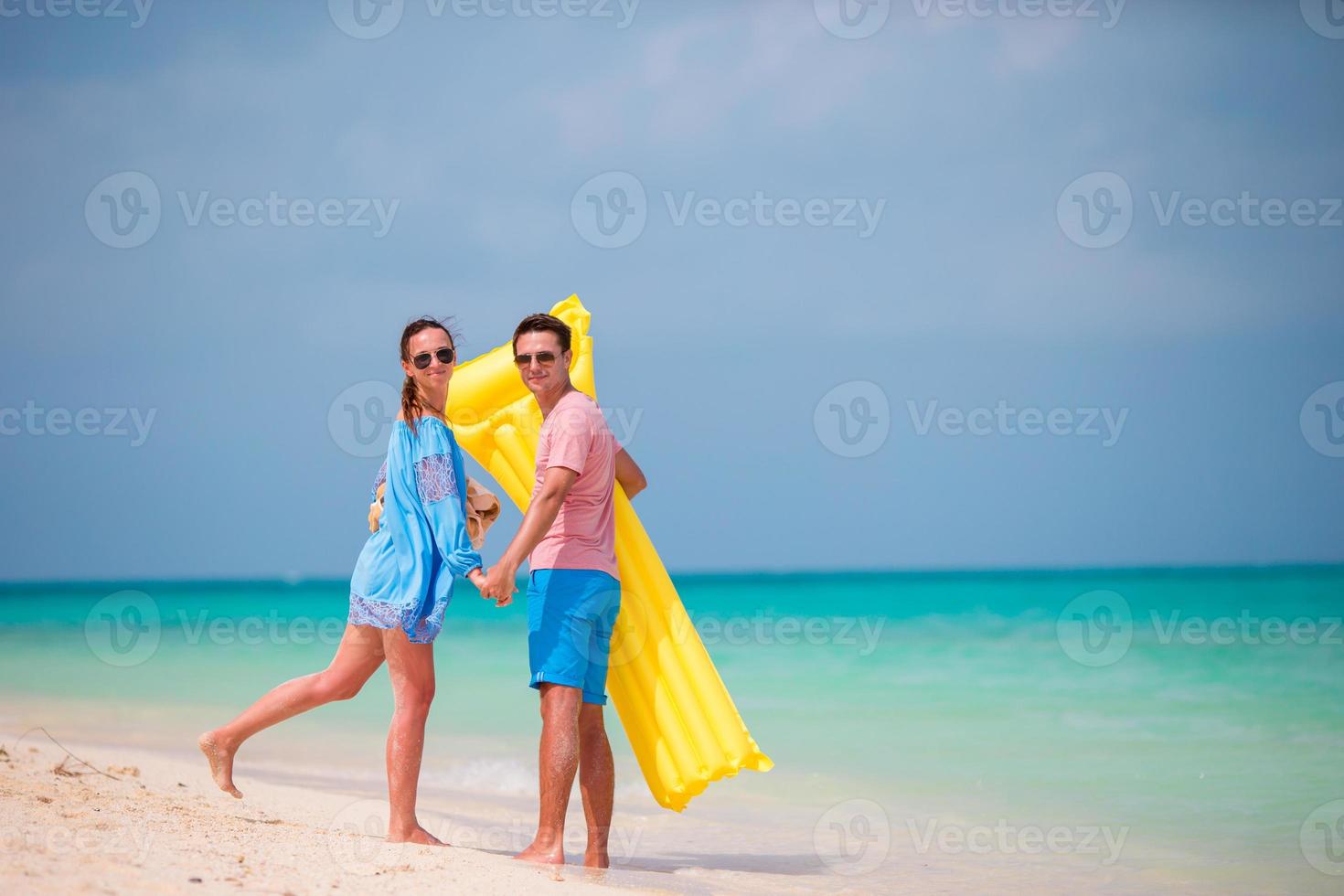 Young couple on white beach at summer vacation photo