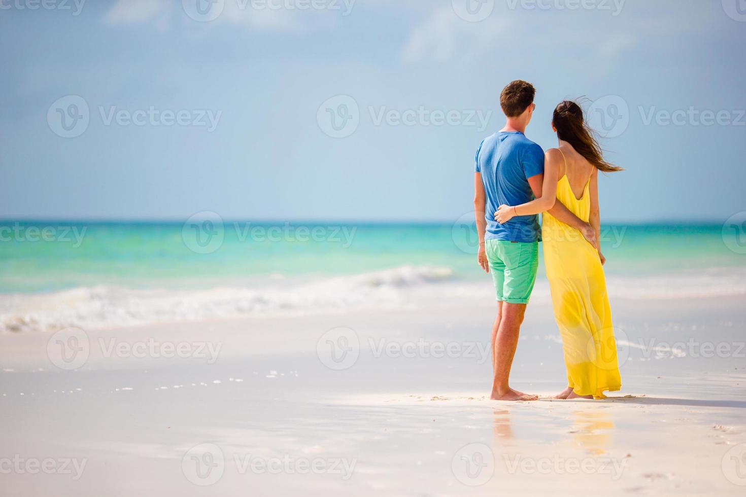 Young happy couple on white beach at summer vacation photo