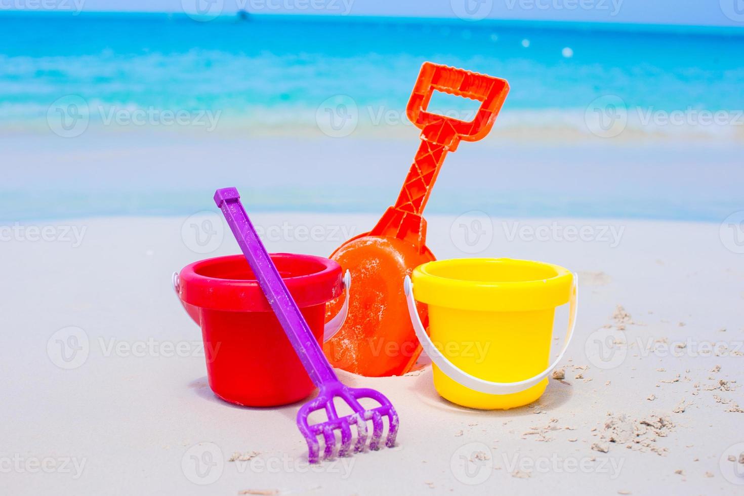 Summer kid's beach toys in the white sand photo