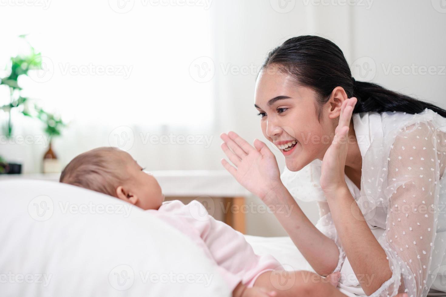 Mother Parenting and newborn birth life. Mom and baby boy playing in sunny bedroom, Family having fun together. childcare, maternity concept. photo