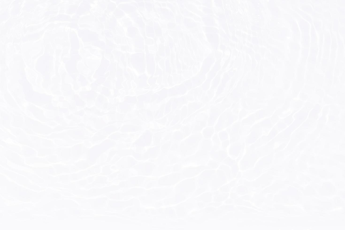 Defocus blurred transparent white colored clear calm water surface texture with splashes and bubbles. Trendy abstract nature background. Water waves in sunlight with copy space. White water shine photo