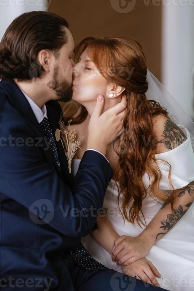 young couple bride and groom in a white dress photo